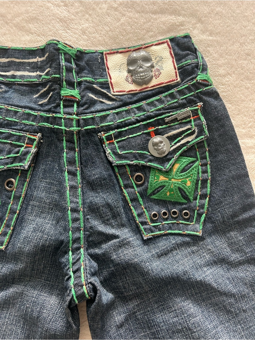 Laguna beach handmade jeans with green stitching and skull detail